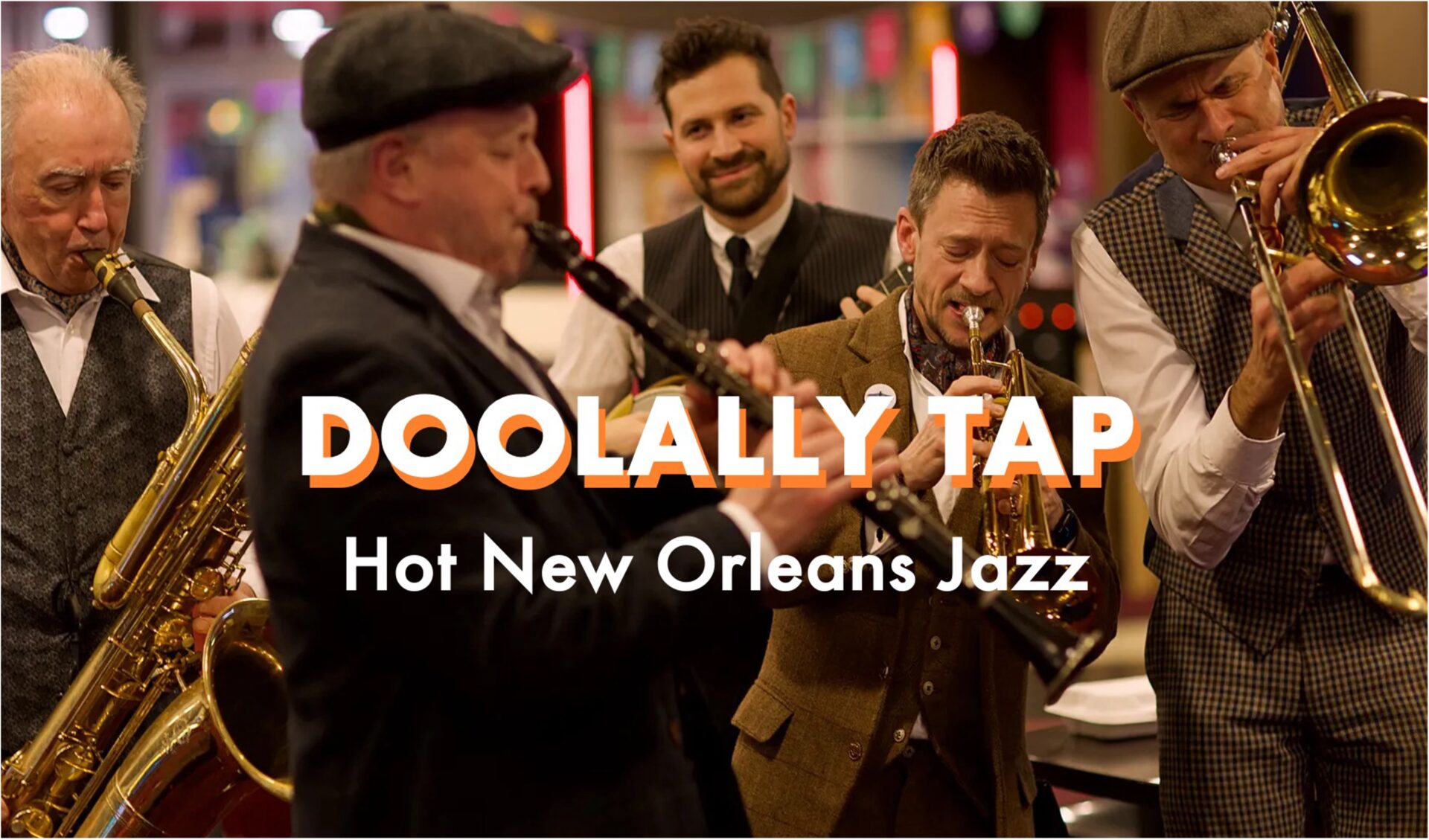 Doolally Tap, all 5 band members playing their instruments with band name text over the image